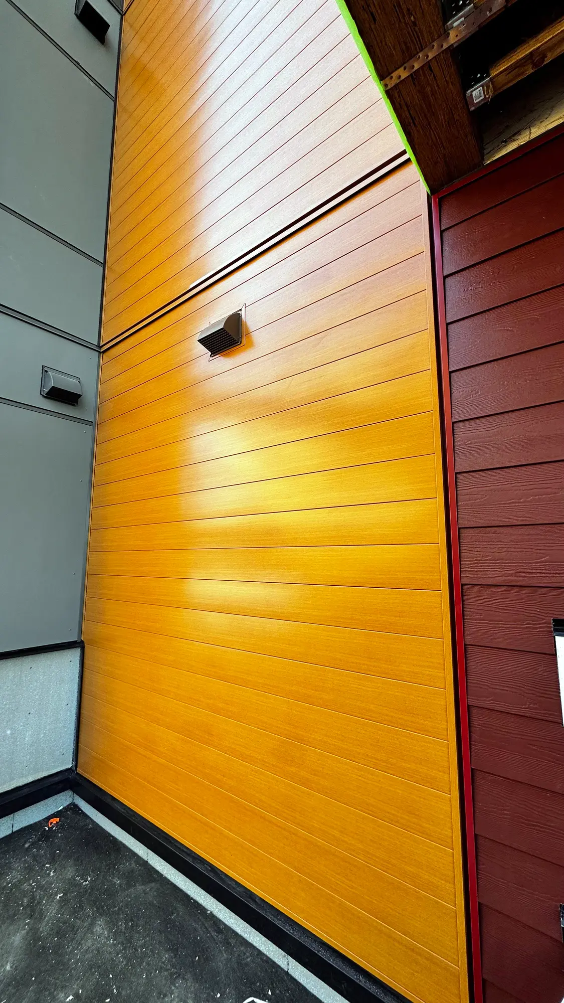 Plank fitted around a wall vent